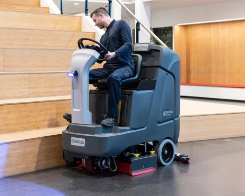 stand-on-ride-on-scrubber-dryers-man-cleaning-gym